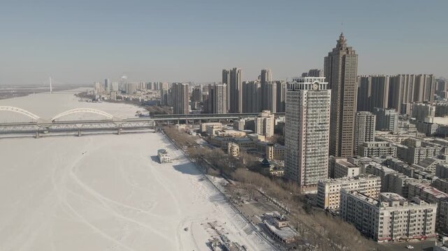 Harbin Skyline Along the Frozen Songhua River in Winter, China in Harbin, China