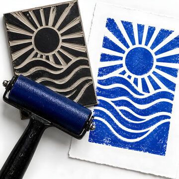 Blue linocut sun and waves print with brayer and carved block