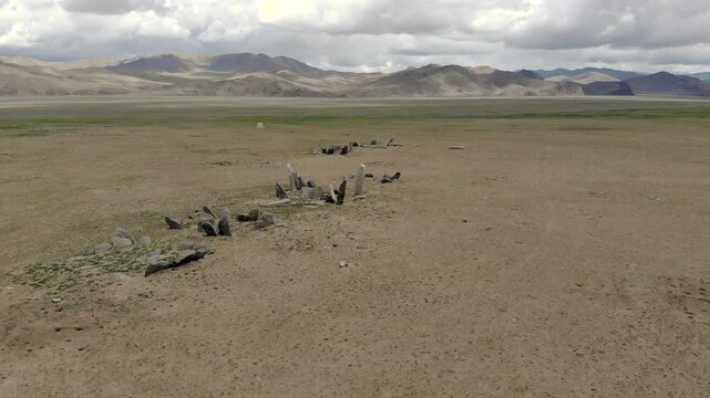 Ancient ritual burial site with deer stones and balbal monuments across Central Asian steppe. Prehistoric stele records nomadic belief, funerary custom, archaeological value, early Eurasian heritage.