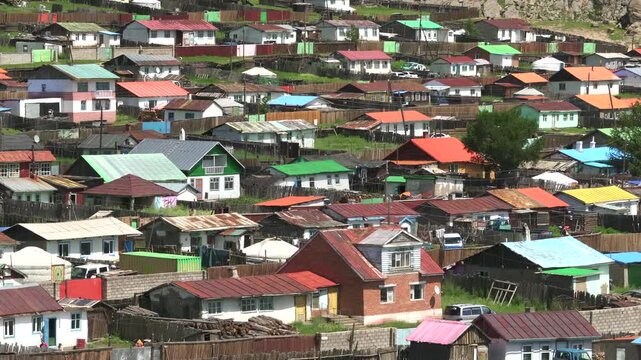 Colorful roofed houses forming dense mixed residential neighborhood panorama view. Vibrant roof pattern creates lively townscape, housing texture, architecture, urban rhythm.