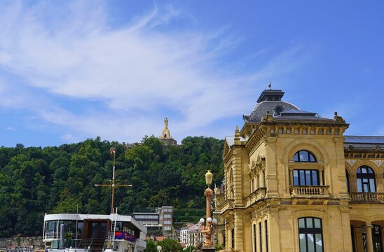 View of the San Sebastian Nautical club, the statue of Jesus on Monte Urgull and the City Hall, in Spain