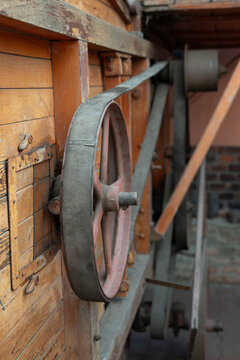 Close-up of a flat belt on a pulley of an old threshing machine.