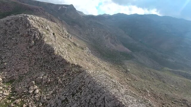 Taurus Mountains in Turkey span barren ridges with sparse trees and open slopes. Stony uplands, exposed landforms, and rugged dry terrain form harsh natural scenery.