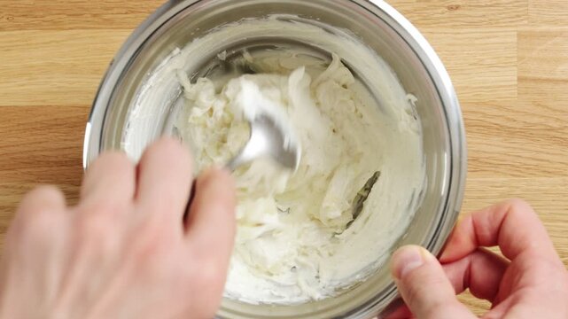 Person mixes pear cubes into ricotta in bowl, timelapse. Creamy fruit mixture makes filling for toast, crostini or tart. Close up cooking background suits recipe video, food blog or kitchen tutorial.