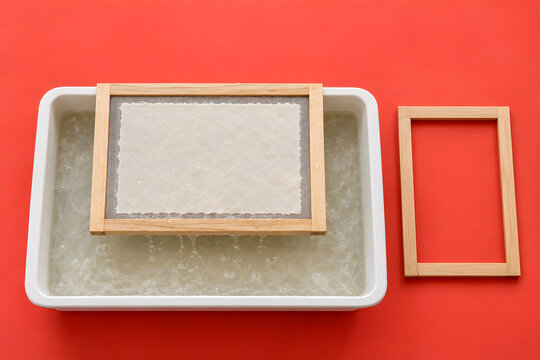 Handmade paper making with mould and deckle in pulp vat
