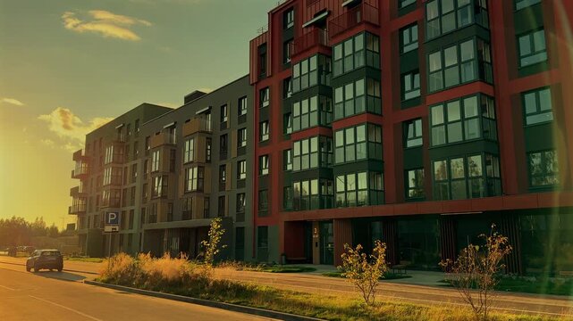 Modern building block in eco neighborhood. Sustainable and affordable housing in green communities. Multi-apartment condo in modern residential complex. Facade of condominium block on sunset.
