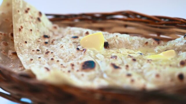 Naan bread on dark background close-up. Paratha and roti. Indian bread 4K video. Chapati and butter naan.