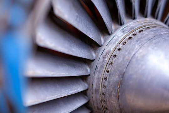 Close-up of jet engine turbine blades. Industrial aviation technology and aircraft machinery detail. Powerful airplane motor concept