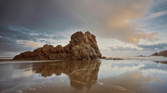 Sea stacks at the easternmost end of the Bayas sandstrip and dune system, the Playa Requexinos Beach, on a glowing dawn. Castrill&oacute;n-Asturias-Spain-045