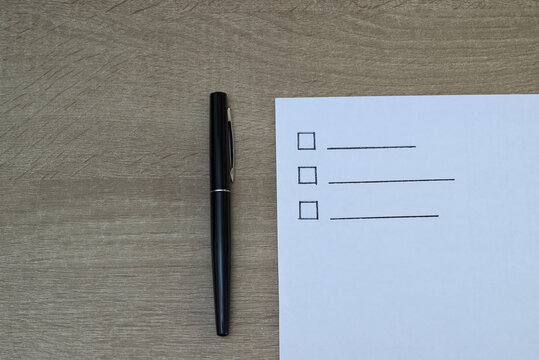 Blank to-do list with checkboxes and black pen