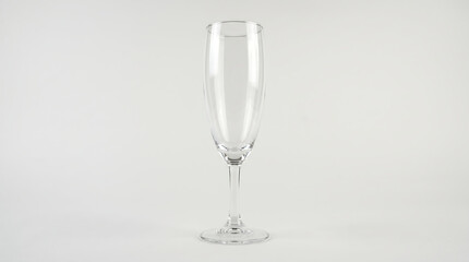 Obraz premium Elegant clear glass champagne flute with a slender stem and round base isolated on a white background isolated on white background