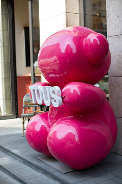 
Erevan, Armenia - August 4, 2025: large pink balloon bear with the word "TOUS" written on it. The sculpture is placed on a gray surface in city centre.