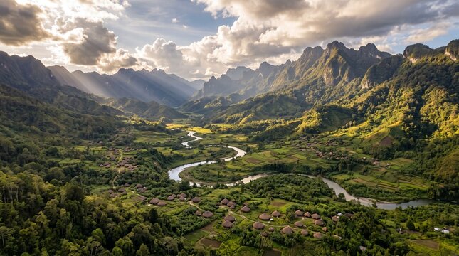 High angle aerial view of a serene tropical valley with a meandering river and traditional indigenous settlements