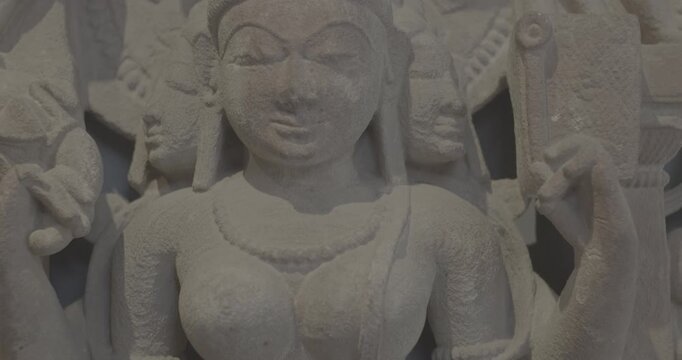 Close-up view on Ancient Stone Bas-relief Of Brahmani Or Brahmi, One Of Seven Hindu Mother Goddesses Known As Sapta Matrikas. Ungraded C LOG 2 She Is Aspect Of Adi Shakti, Possessing rajas Guna And Is