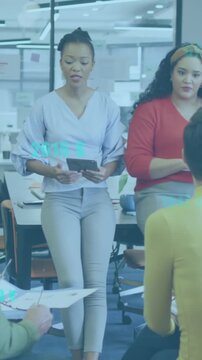 Animation of data processing against team of diverse colleagues discussing together at office