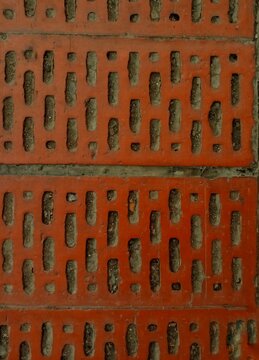 Perforated red brick wall pattern