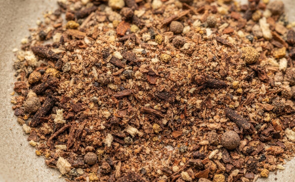 Mulling spices blend closeup texture with aromatic herbs, cinnamon, cloves and allspice for homemade winter hot drinks, mulled wine, and festive holiday recipes