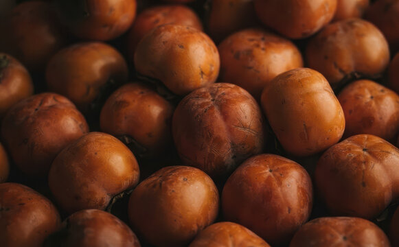 Fresh ripe persimmons close up macro shot of vibrant orange kaki fruits harvest background