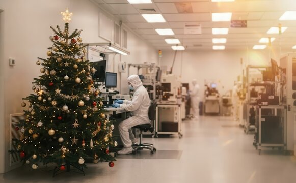 Christmas tree in a cleanroom semiconductor manufacturing lab with technicians wearing cleanroom suits working