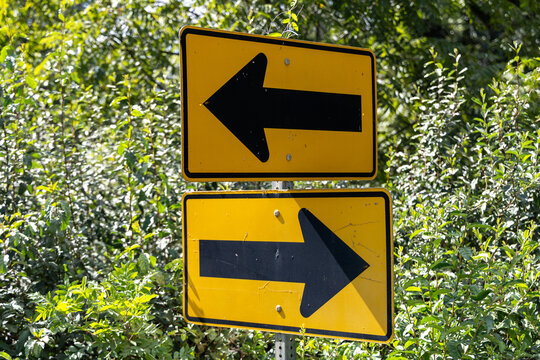 Opposing Directional Arrow Signs on Sharp Rural Road Bend