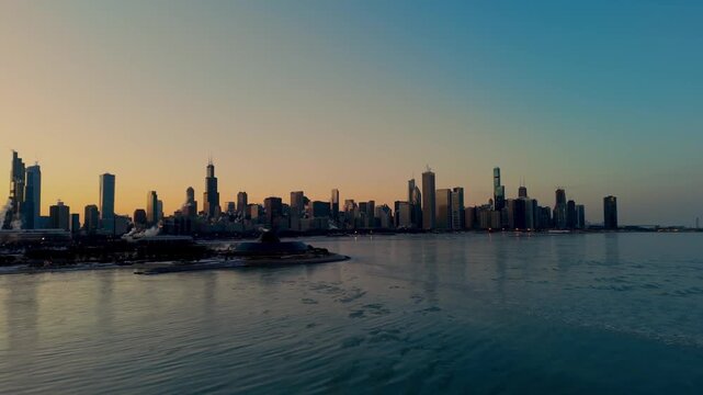Chicago skyline over Lake Michigan at sunset with downtown skyscrapers