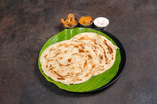 Flaky South Indian parotta with flavorful kurma