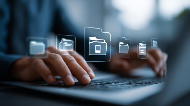 Professional managing digital files and folders on a laptop computer interface.