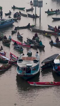 Traders sell produce from wooden boats on rivers in South Kalimantan, Indonesia