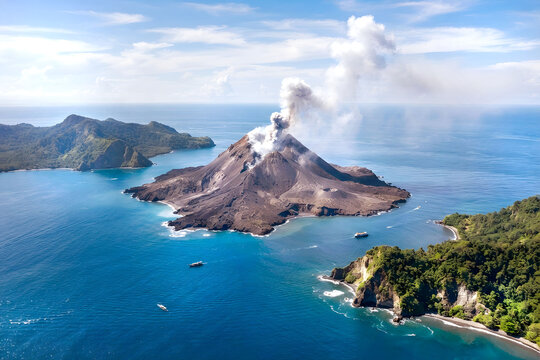 Aerial view of  active Anak Krakatau volcano with smoke rising at Sunda strait in Indonesia