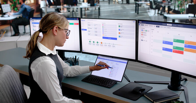 Woman Reviews Employee Performance On Laptop