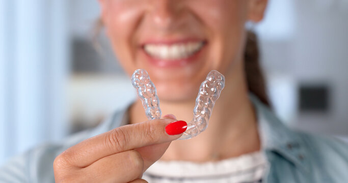 Young Woman Shows Clear Dental Guards