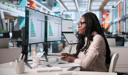 Young Woman Studies Carbon Footprint Data On Laptop