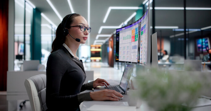 Woman Using Laptop To Manage Customer Calls