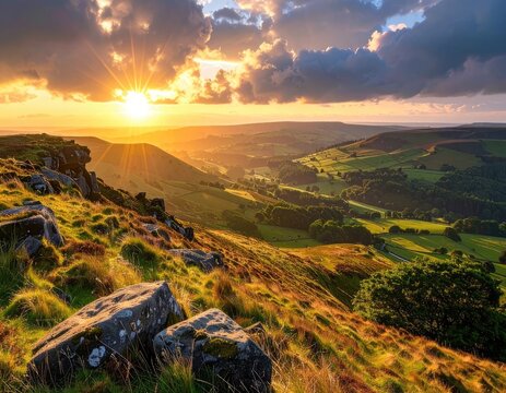Golden sunset illuminates rolling hills and rocky terrain.