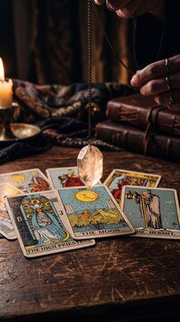 Fortune Teller Using Crystal Pendulum Over Tarot Cards for Divination