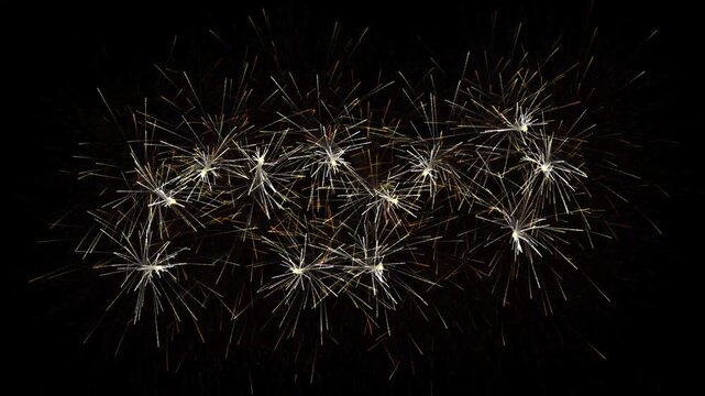 Exploding golden starburst fireworks against dark background explosion sparkles night illumination pyrotechnics 4K video