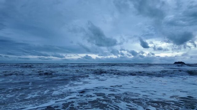 Tropical beach and ocean coastline on Koh Chang under an overcast sky in Thailand