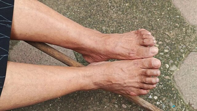 Adult Woman Bare Feet Resting On Concrete Ground