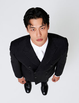 Overhead view of man in pinstripe suit standing, fashion