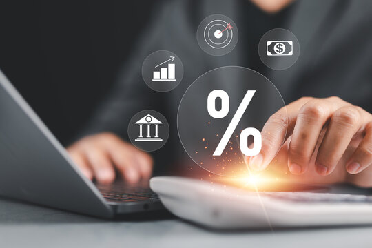 Financial planning and interest rate calculation, businessman using calculator and laptop with digital finance icons for investment, banking, and growth strategy.