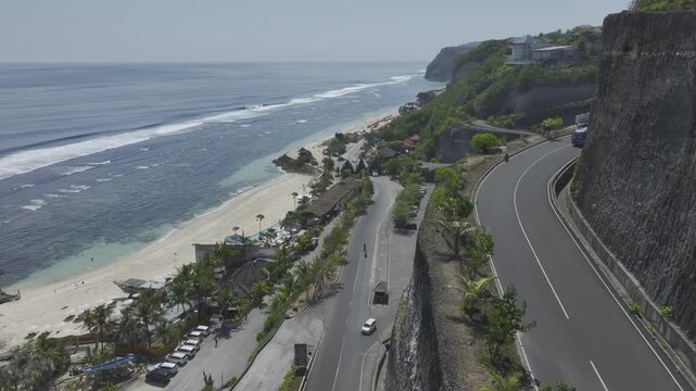 Aerial view of road across Melasti beach and cliff in Bali island, Indonesia