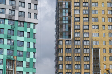 Fototapeta premium Modern architecture shines in an urban landscape with colorful buildings standing tall against a cloudy sky