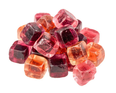Close up of vibrant red and orange garnet gemstones in a scattered pile isolated on transparent background