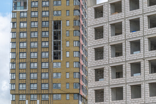 Modern architecture showcases a blend of completed and under-construction buildings in an urban landscape during daylight