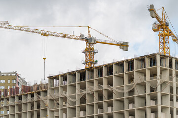 New skyscraper rises above the city skyline as cranes work diligently to shape the future of urban living © beholdereye
