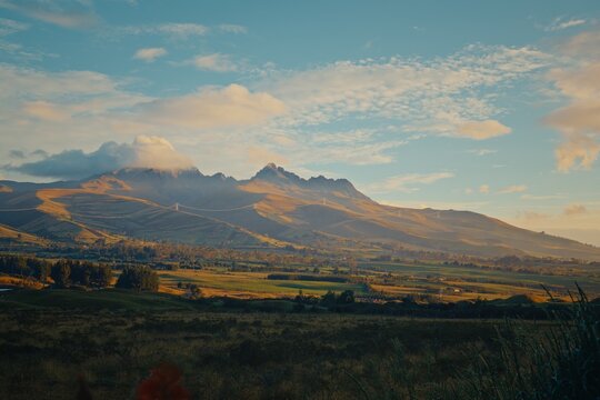 Cotopaxi volcano with power lines and rolling hills in Ecuador