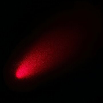 Intense red spotlight beam emerging from deep darkness with red light dark background red glow stage lighting
