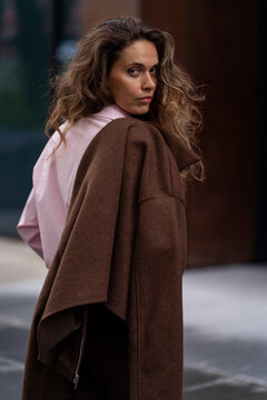 Young woman looking back over shoulder with jacket in the city