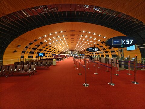 Paris, France-Dec.3rd 2025: Interior view of Terminal 2E at Paris Charles de Gaulle Airport, arched wooden ceiling, red carpet and boarding gates