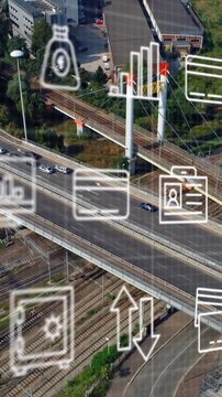 Animation of multiple icons over aerial view of moving vehicles on roads in city